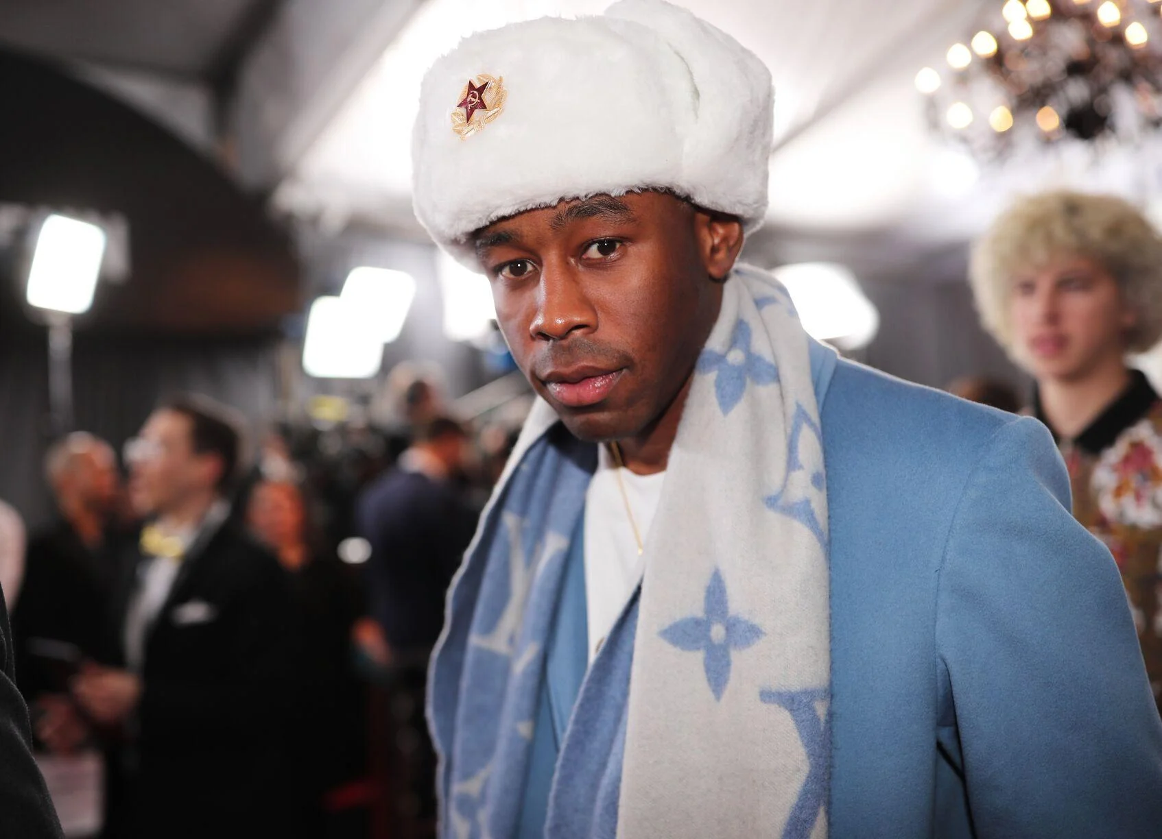 a man wearing a white hat and scarf